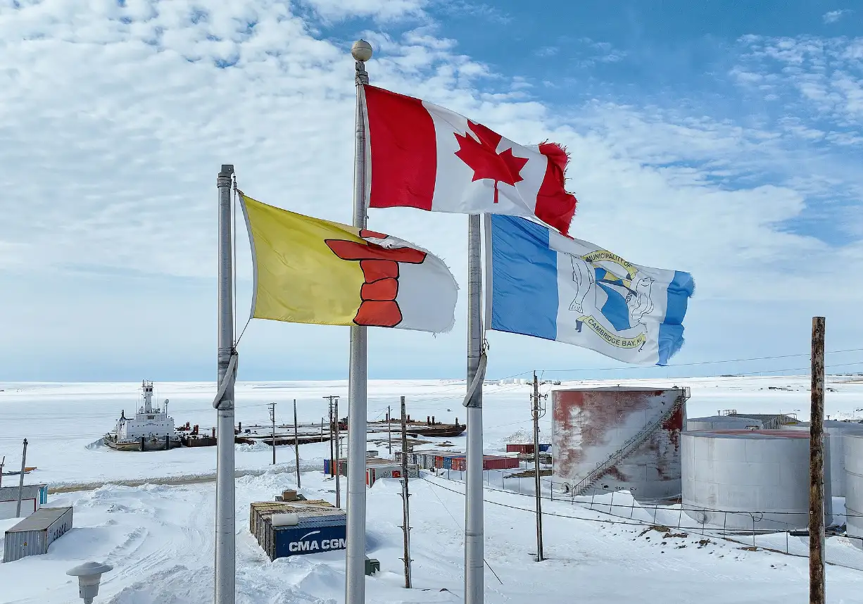 Nunavut, Canada and Cambridge Bay flags in winter